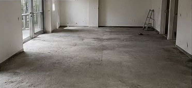 The same room after construction cleaning, clear floors ready for finishing